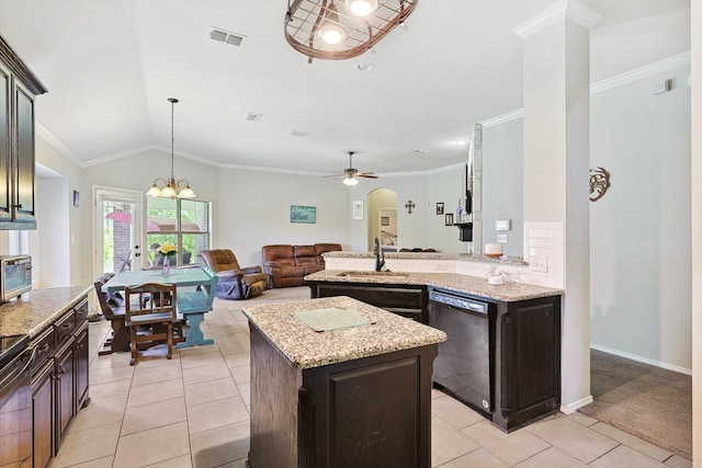 kitchen with light stone counters, dark brown cabinetry, black dishwasher, and a kitchen island