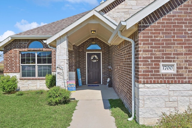 doorway to property featuring a lawn