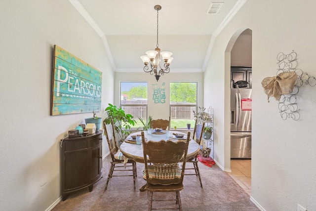 tiled dining space featuring crown molding, lofted ceiling, and a notable chandelier