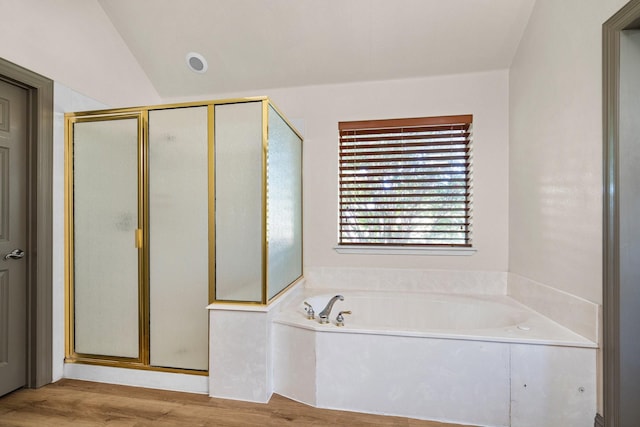 bathroom with wood-type flooring, lofted ceiling, and independent shower and bath