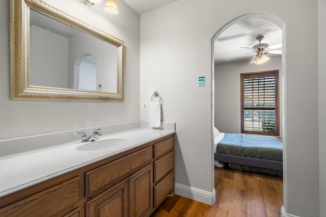 bathroom featuring hardwood / wood-style flooring, ceiling fan, and vanity