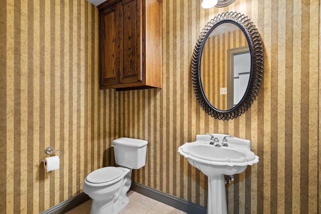 bathroom featuring toilet and tile patterned flooring