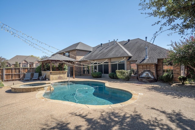 view of swimming pool featuring an outdoor fireplace, a patio, a gazebo, and an in ground hot tub