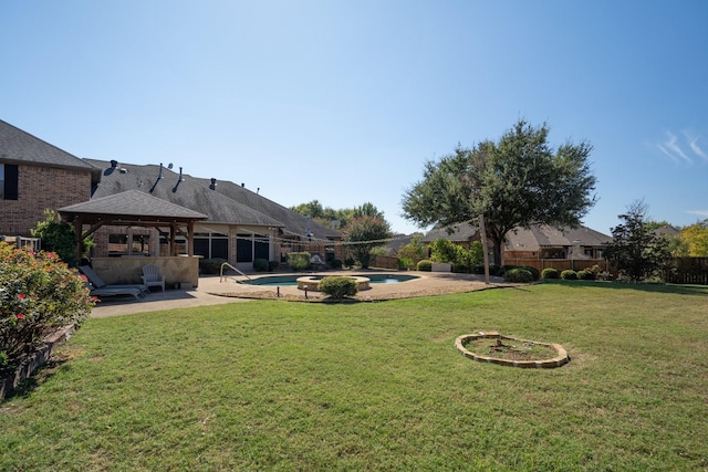 view of yard with a fenced in pool, a patio area, and a gazebo