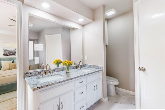 bathroom featuring toilet and vanity