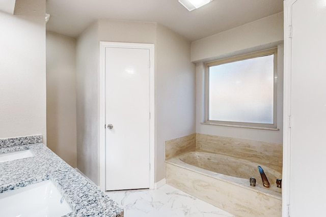 bathroom with vanity and a bath