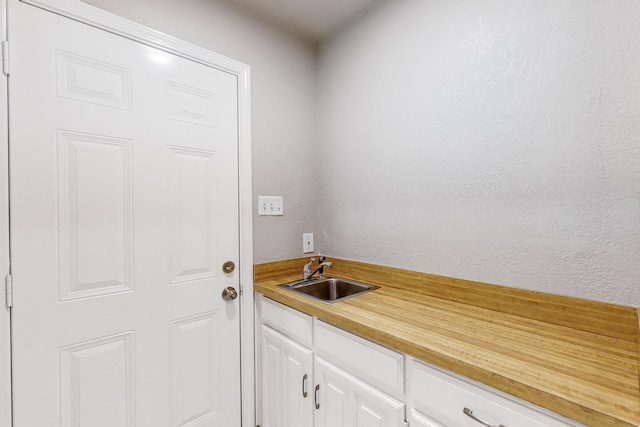 clothes washing area with sink