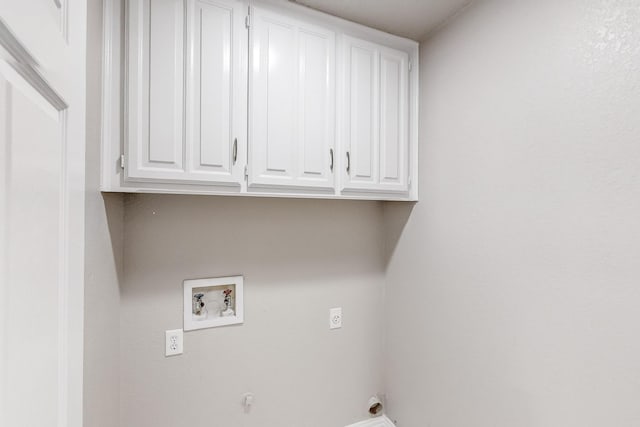 clothes washing area with hookup for a washing machine, cabinets, and hookup for an electric dryer