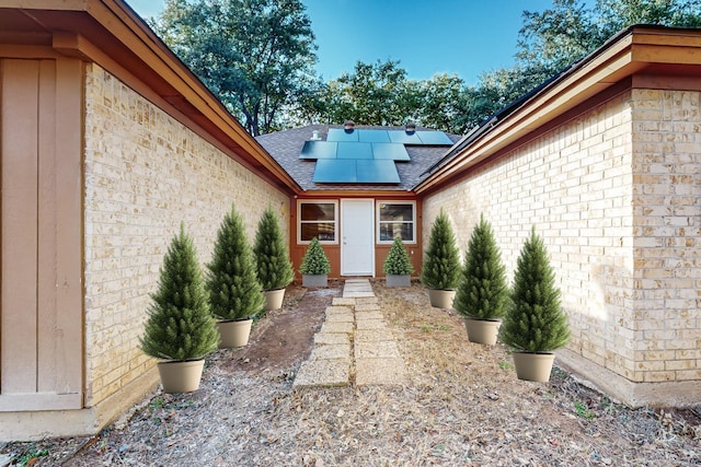 view of exterior entry with solar panels