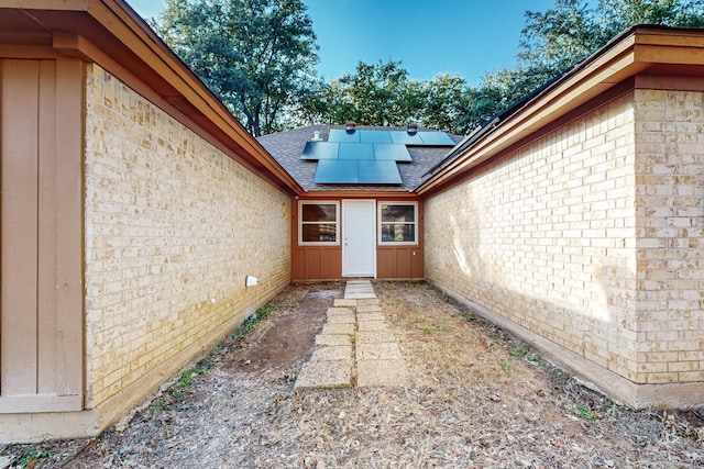 doorway to property featuring solar panels