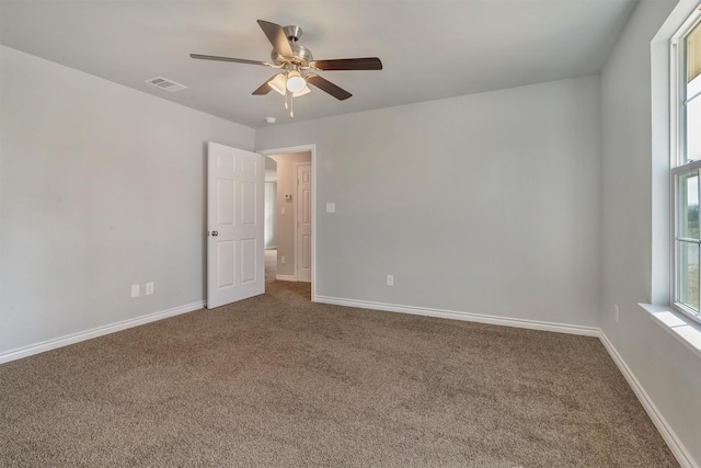 spare room with ceiling fan and carpet flooring