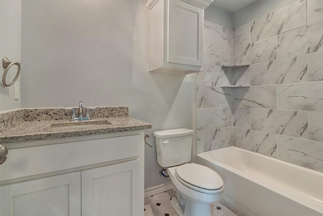 full bathroom with toilet, vanity, and tiled shower / bath