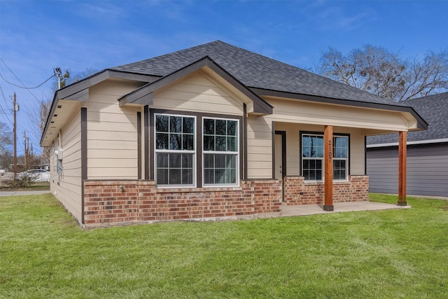 rear view of property with a yard