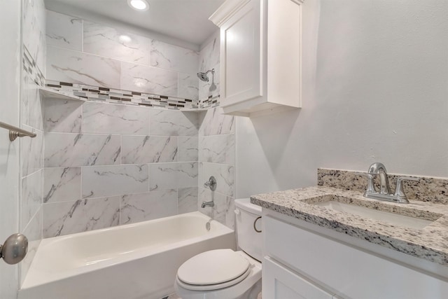 full bathroom with toilet, tiled shower / bath, and vanity