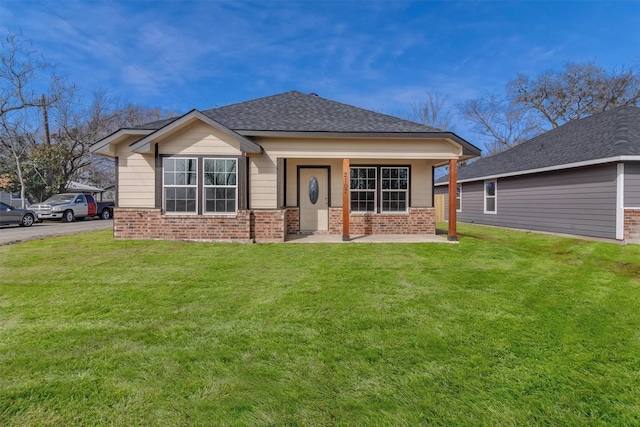 view of front of home with a front yard and a porch