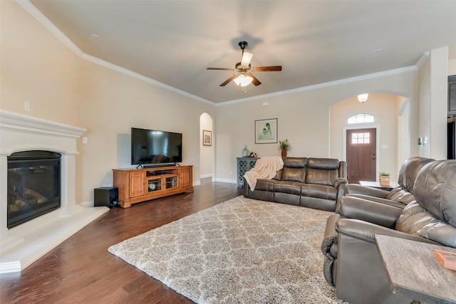 living room featuring crown molding, dark wood-type flooring, and ceiling fan