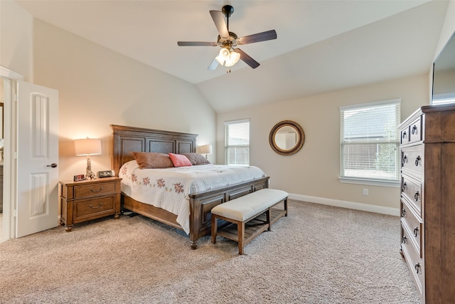 carpeted bedroom with ceiling fan and vaulted ceiling