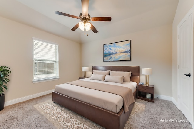 bedroom featuring light colored carpet and ceiling fan