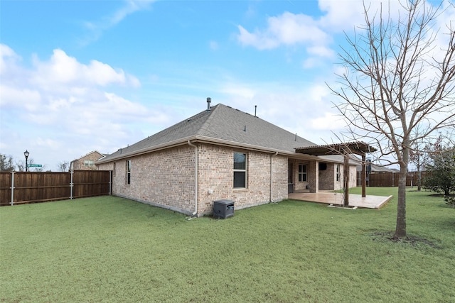 rear view of house featuring a pergola, a lawn, and a patio