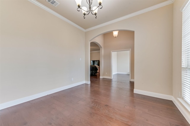 unfurnished room with ornamental molding, hardwood / wood-style floors, and a notable chandelier