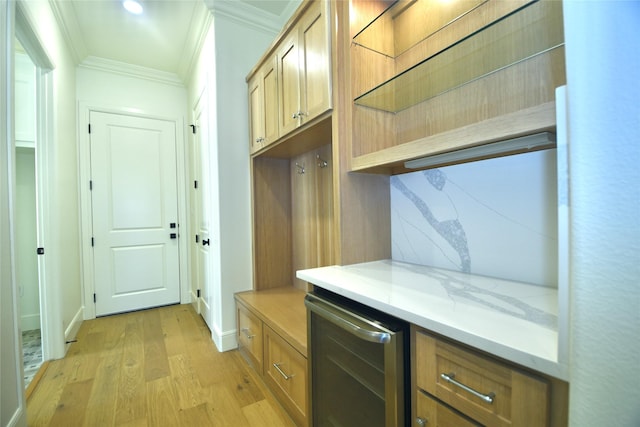 mudroom featuring beverage cooler, crown molding, and light wood-type flooring