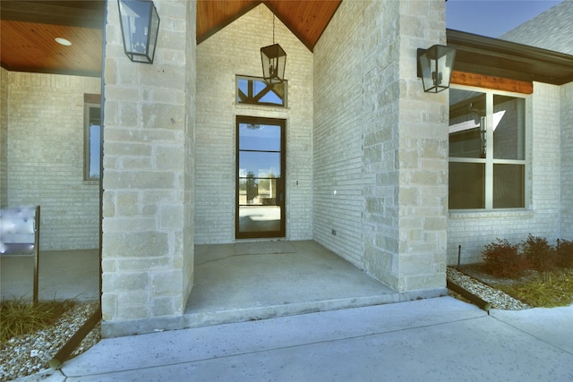 view of exterior entry featuring a patio area