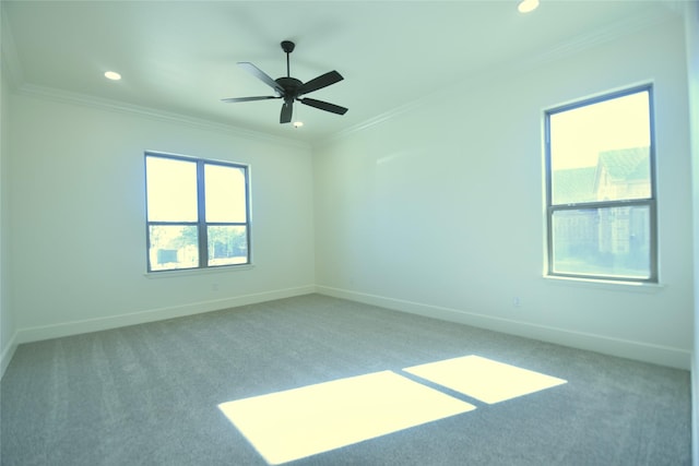 empty room with ceiling fan, light colored carpet, and ornamental molding