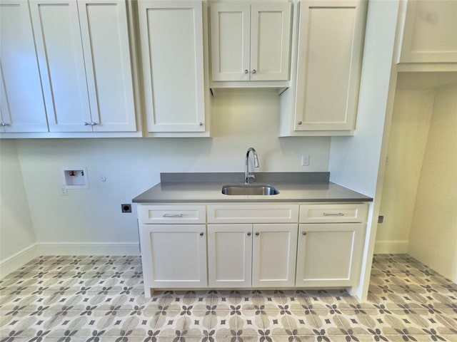 kitchen featuring white cabinets and sink