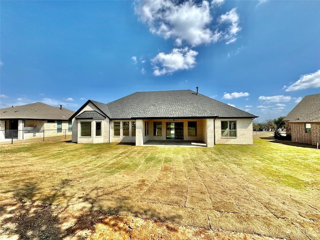 back of property with a patio area and a lawn