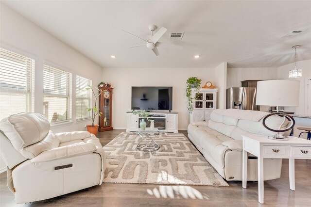 living room with hardwood / wood-style flooring and ceiling fan