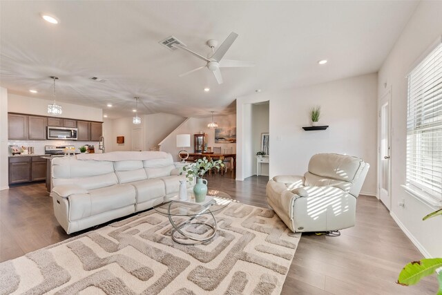 living room with hardwood / wood-style flooring and ceiling fan