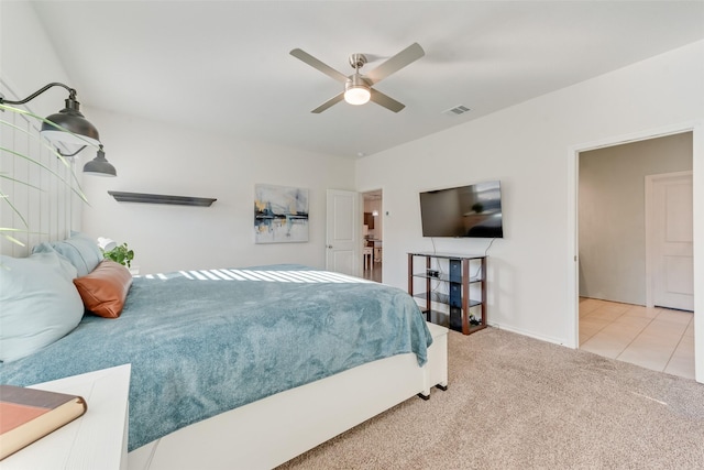 carpeted bedroom with tile patterned floors, a ceiling fan, and visible vents