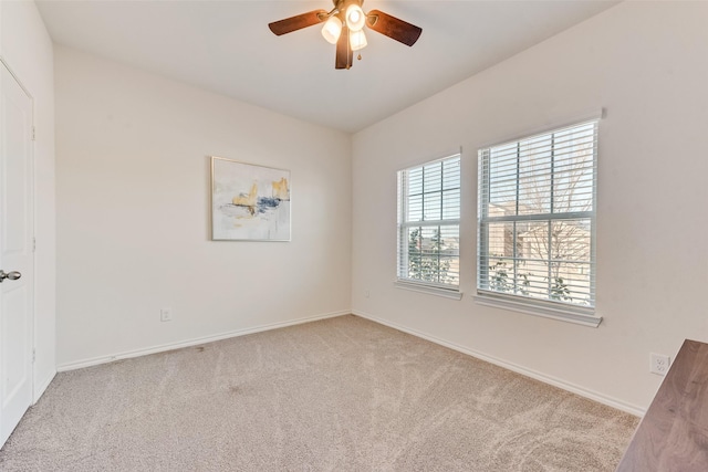 unfurnished room featuring baseboards, carpet, and ceiling fan