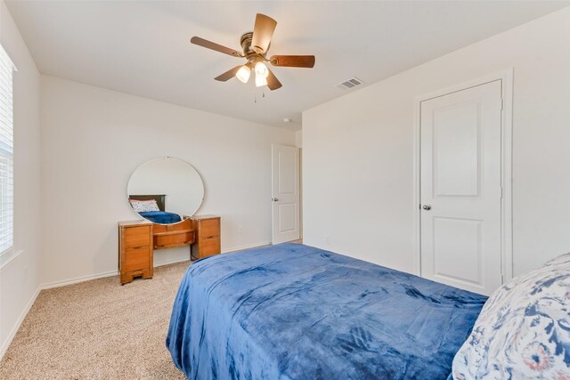 bedroom featuring light carpet and ceiling fan