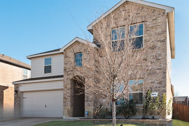 traditional-style home featuring stone siding, concrete driveway, a garage, and fence