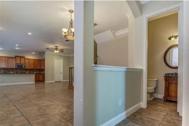 interior space featuring ornamental molding and an inviting chandelier