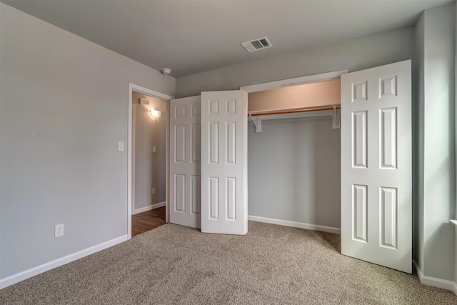 unfurnished bedroom with a closet and carpet flooring