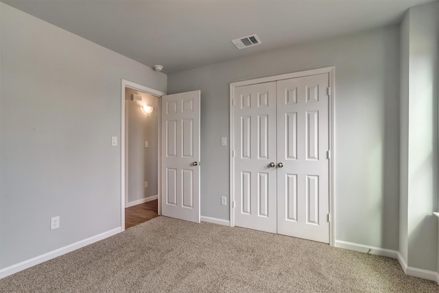 unfurnished bedroom featuring a closet and carpet floors