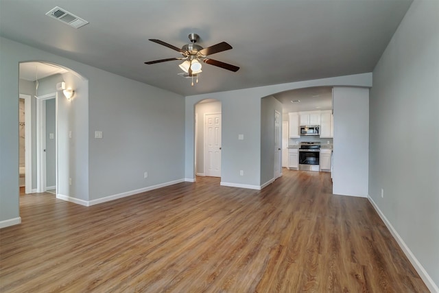 unfurnished living room with ceiling fan and light hardwood / wood-style flooring