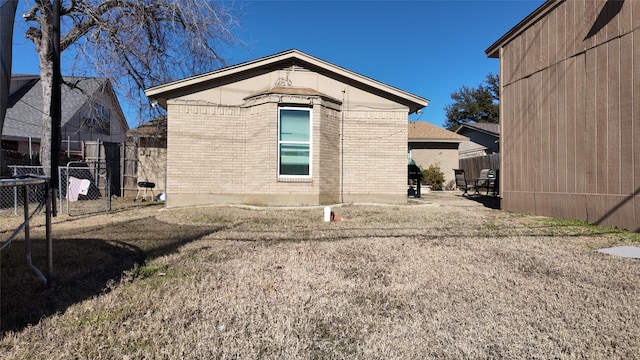 rear view of property featuring a lawn