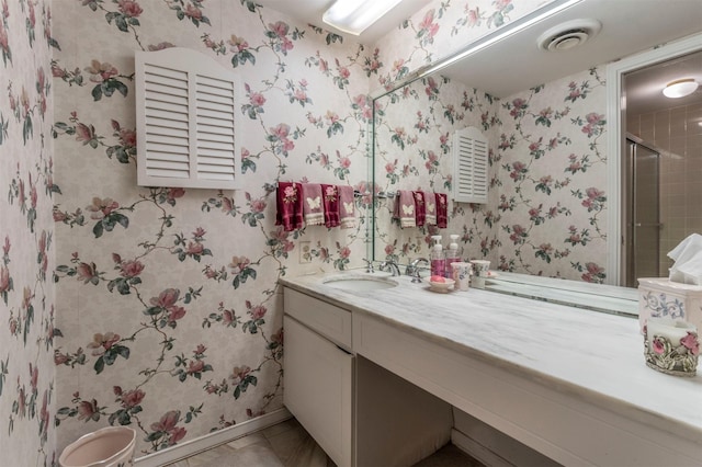 bathroom with vanity, tile patterned floors, and a shower with door