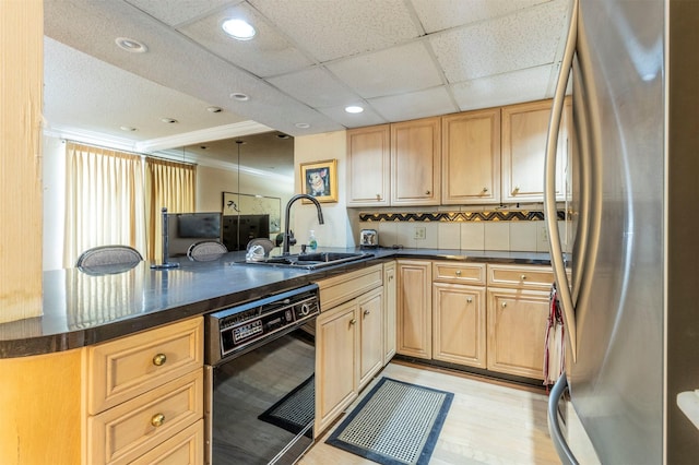 kitchen featuring black dishwasher, stainless steel refrigerator, decorative backsplash, sink, and kitchen peninsula