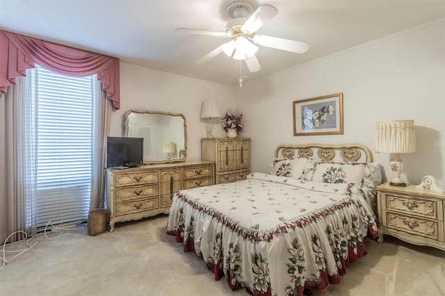 carpeted bedroom with ceiling fan and crown molding