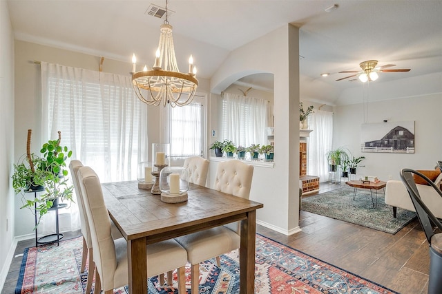 dining room with vaulted ceiling, dark hardwood / wood-style flooring, and ceiling fan with notable chandelier