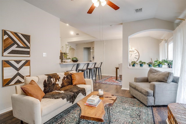 living room featuring lofted ceiling, ceiling fan, and dark wood-type flooring