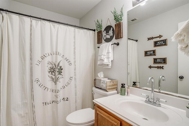 bathroom with toilet and vanity