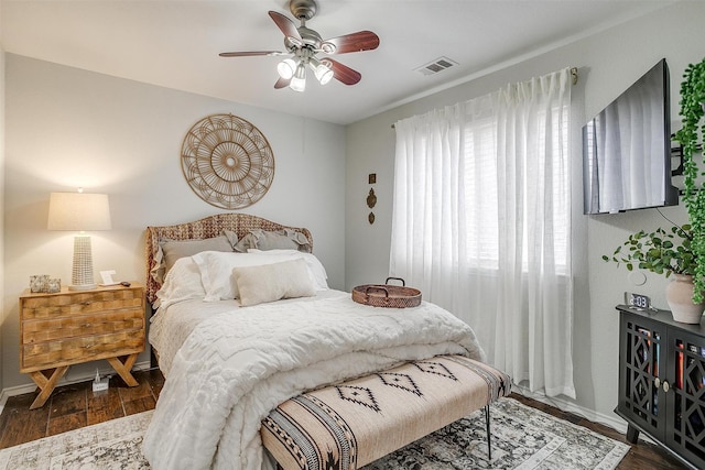 bedroom with ceiling fan and dark wood-type flooring