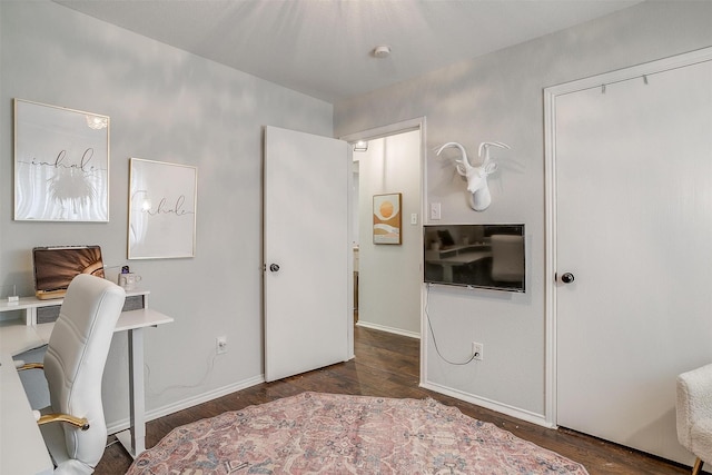 bedroom with dark hardwood / wood-style flooring