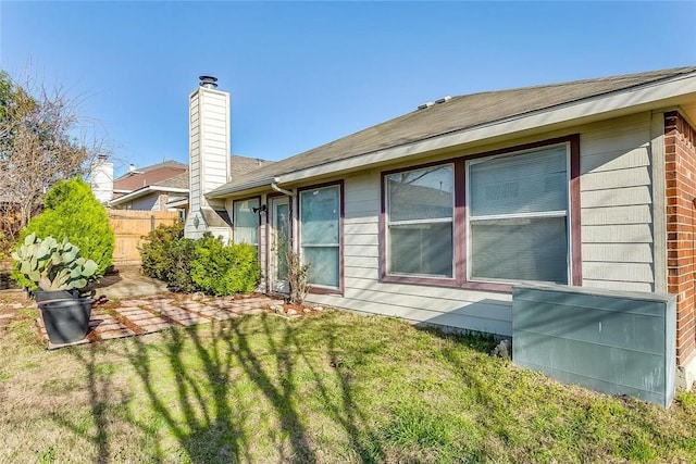 rear view of house featuring a yard