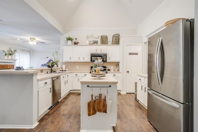 kitchen with sink, white cabinetry, appliances with stainless steel finishes, and a kitchen island